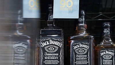 This July 9, 2018 photo shows bottles of Jack Daniel's whiskey displayed at Rossi's Deli in San Francisco. China's government vowed Wednesday, July 11, to take 'firm and forceful measures' as the U.S. threatened to expand tariffs to thousands of Chinese imports. After the U.S. imposed 25 percent tariffs on $34 billion worth of Chinese goods, China retaliated by imposing tariffs on the same amount of U.S. products including whiskey.