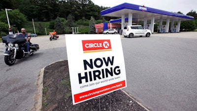 In this June 20, 2018, photo, a 'Now Hiring' sign is posted outside a gas station in Raymond, N.H. On Tuesday, July 10, the Labor Department reports on job openings and labor turnover for May.