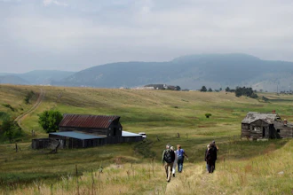-In this Aug. 11, 2017 file photo, visitors approach a former ranch house and barn during a guided hike on the Rocky Flats National Wildlife Refuge near Denver, land that used to be a buffer zone around a nuclear weapons plant. Environmentalists and community activists are trying to stop the refuge from opening to the public this summer, claiming the U.S. Fish and Wildlife Service did not adequately study the safety of the site.