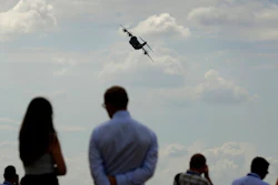 Spectators watch an Airbus 400M take part in a flying display at the Farnborough Airshow in Farnborough, England, Monday, July 16, 2018.