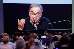 In this June 1, 2018, file photo, journalists watch a giant screen as Fiat Chrysler CEO Sergio Marchionne speaks during the 'Capital market day' at the FCA headquarters in Balocco, Italy. Fiat Chrysler’s late founding CEO Sergio Marchionne was a notorious workaholic who regularly slept on a corporate jet all the while landing in headlines for his shrewd deal-making. Despite his public profile, he kept a secret even from his board: he’d been seriously ill for more than a year.