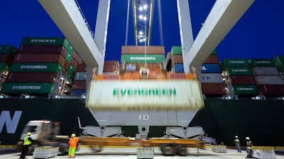 In this June, 19, 2018, file photo, an Evergreen Line refrigerated container is lifted by a ship to shore crane onto the container ship Ever Linking at the Port of Savannah in Savannah, Ga. The U.S. trade deficit dropped in May to the lowest level in 19 months as U.S. exports rose to a record level. But the trade gap between the United States and China increased sharply, underscoring the economic tensions between the world’s two biggest economies.