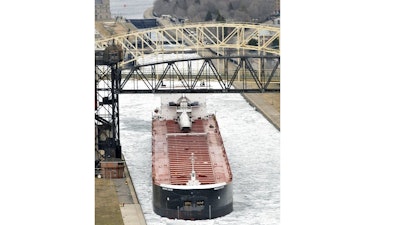 In this April 22, 2014 file photo, the carrier American Century moves out of the Soo Locks in Sault Ste. Marie, Mich., headed into Whitefish Bay, where an icebreaker escort awaits to lead the ship and others across the ice-clogged Lake Superior. Michigan officials say the federal government is taking a big step toward approving a long-sought project to boost cargo shipping on the Great Lakes. Gov. Rick Snyder and members of Congress say a U.S. Army Corps of Engineers report improves prospects for constructing a second navigation lock that can accommodate the largest vessels hauling iron ore and other cargo between Lake Superior and the other lakes.