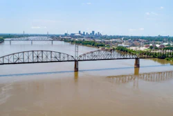 In this photo made Wednesday, June 27, 2018, the Merchants Bridge is seen in the foreground as it crosses the Mississippi River as the St. Louis skyline is seen in the distance. The 127-year-old railroad bridge is in danger of being shut down if it is not replaced soon, but officials are struggling with how to pay for a planned repair and the 12,500 tons of steel the project would require after tariffs were recently enacted.