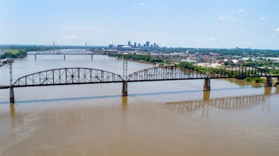 In this photo made Wednesday, June 27, 2018, the Merchants Bridge is seen in the foreground as it crosses the Mississippi River as the St. Louis skyline is seen in the distance. The 127-year-old railroad bridge is in danger of being shut down if it is not replaced soon, but officials are struggling with how to pay for a planned repair and the 12,500 tons of steel the project would require after tariffs were recently enacted.