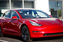 In this May 27, 2018, file photo, a 2018 Model 3 sedan sits at a Tesla dealership in Littleton, Colo. Tesla Inc. made 5,031 lower-priced Model 3 electric cars during the last week of June, surpassing its often-missed goal of 5,000 per week. Tesla reported making 28,578 Model 3s from April through June, according to its quarterly production release on Monday, July 2.