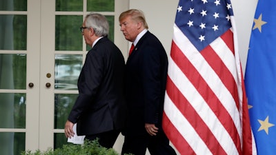 President Donald Trump and European Commission president Jean-Claude Juncker walk to the Oval Office after speaking in the Rose Garden of the White House.