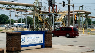 In this June 28, 2018 photo, a car passes through an entrance to the U.S. Steel Granite City Works facility in Granite City, Ill. President Donald Trump will visit the facility on Thursday, July 26, 2018. U.S. Steel credited Trump's plan to impose tariffs on imported steel and aluminum when the company announced in March it was firing up a furnace at Granite City Works that had been idled for more than two years.