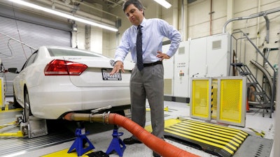 In this Sept. 30, 2015, file photo, John Swanton, spokesman with the California Air Resources Board, explains how a 2013 Volkswagen Passat with a diesel engine is evaluated at the emissions test lab in El Monte, Calif. A U.S. appeals court on Monday, July 9, 2018, approved a $10 billion settlement between Volkswagen and car owners caught up in the company's emissions cheating scandal.
