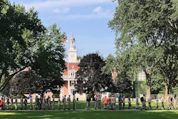 In this Monday, July 16, 2018 photo, students from the Corps of Cadets march in front of Jackman Hall, rear, on the campus of Norwich University in Northfield, Vt. Norwich has become the latest school to offer income share agreements, where colleges receive a percentage of the student's future salary, in place of some student loans.