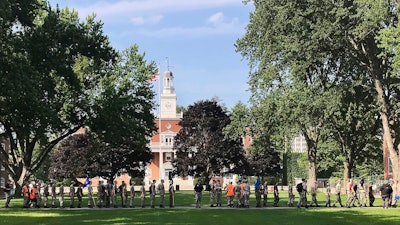 In this Monday, July 16, 2018 photo, students from the Corps of Cadets march in front of Jackman Hall, rear, on the campus of Norwich University in Northfield, Vt. Norwich has become the latest school to offer income share agreements, where colleges receive a percentage of the student's future salary, in place of some student loans.