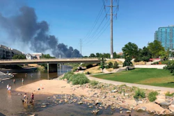 Firefighters are battling a large blaze at a metal recycling facility that sent up a large, black plume of smoke that could be seen for miles just north of downtown Denver, Tuesday, July 10, 2018. Fire crews from Denver and Adams County responded to the fire, which was reported at EVRAZ Recycling on Tuesday afternoon.