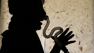 Joelle Dobrow demonstrates how she puts on her sleep apnea breathing device at her home in Los Angeles Thursday, July 12, 2018. It's been two decades since doctors fully recognized that breathing that stops and starts during sleep is tied to a host of health issues, even early death, but there still isn't a treatment that most people find easy to use. Dobrow said it took her seven years to find one she liked. 'I went through 26 different mask styles,' she said. 'I kept a spreadsheet so I wouldn't duplicate it.'