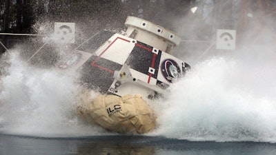 In this Feb. 9, 2016 photo made available by NASA, a mockup of Boeing’s CST-100 Starliner spacecraft, in development in partnership with NASA’s Commercial Crew Program, splashes into a 20-foot-deep basin at NASA’s Langley Research Center in Hampton, Va., during testing of the spacecraft’s landing systems design. On Wednesday, July 11, 2018, the U.S. Government Accountability Office said NASA needs a backup plan for getting astronauts to space, given additional delays on the horizon for new commercial crew capsules.