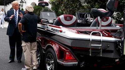 President Donald Trump talks with Jimmy Houston of Ranger Boats as he participates in a tour during a 'Made in America Product Showcase' at the White House, Monday, July 23, 2018, in Washington.
