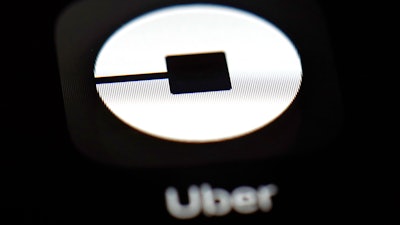 This March 20, 2018, file photo shows the Uber app on an iPad in Baltimore. Uber’s chief human resources officer has abruptly stepped down. Liane Hornsey told employees in an email Wednesday, July 11, that she is leaving the company but gave no reason. The email was obtained by The Associated Press. Hornsey writes that employees may think the decision came out of the blue, but she has been thinking about leaving for a while.
