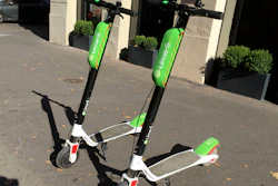 This July 3, 2018, photo shows scooters by Lime in Paris. Uber is getting into the scooter-rental business. The ride-hailing company said Monday, July 9, that it is investing in Lime, a startup based in San Mateo, California.