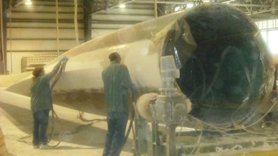 This photo posted on May 25, 2012 shows two workers at the Molded Fiberglass wind turbine plant in Aberdeen.