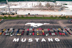 In this photo provided by the Ford Motor Co., Mustang vehicles are parked to spell out '10,000,000' on a parking lot at the Flat Rock Assembly plant, Wednesday, Aug. 8, in Flat Rock, Mich. The commas were represented by the first Mustang produced and the 10 millionth, a 2019 Wimbledon White GT V8 six-speed manual convertible.