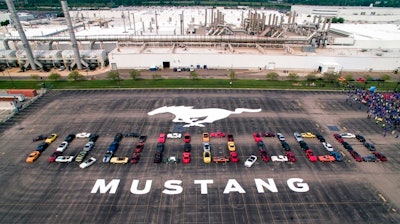 In this photo provided by the Ford Motor Co., Mustang vehicles are parked to spell out '10,000,000' on a parking lot at the Flat Rock Assembly plant, Wednesday, Aug. 8, in Flat Rock, Mich. The commas were represented by the first Mustang produced and the 10 millionth, a 2019 Wimbledon White GT V8 six-speed manual convertible.