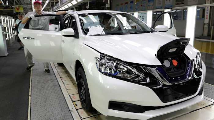A worker inspects a Nissan Sylphy Zero Emission, Nissan's first all-electric vehicle built in China, at a production line in Guangzhou, Guangdong province, China, Monday, Aug. 27, 2018. The Sylphy is part of a wave of dozens of electric models planned by global automakers for China where the government is pressing them to accelerate development of the technology.