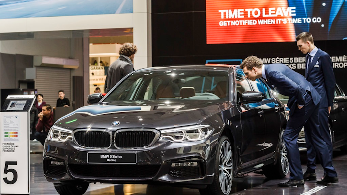 In this Jan. 13, 2017, file photo men look at a BMW 5 series during the media day of the 95th European Motor Show in Brussels. The Insurance Institute for Highway Safety, in a paper titled “Reality Check,” issued the warning Tuesday, Aug. 7, 2018, after testing five of the systems from Tesla, Mercedes, BMW and Volvo on a track and public roads. The systems tested, in the Tesla Model 3 and Model S, BMW’s 5-Series, the Volvo S-90 and the Mercedes E-Class, are among the best in the business right now and have been rated “superior” in previous IIHS tests. David Zuby, the institute’s chief research officer, said the systems do increase safety but the tests show they are not 100 percent reliable.