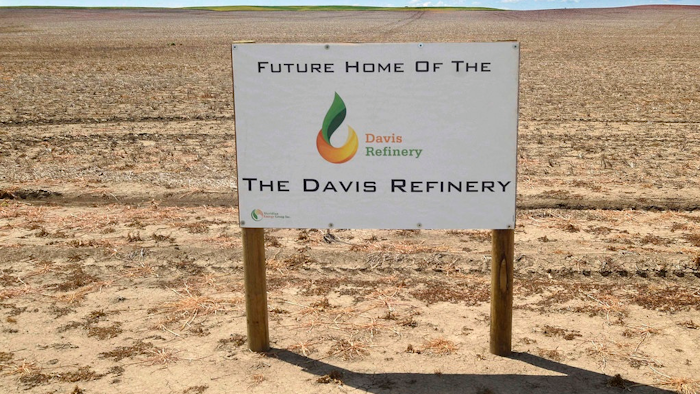 This July 19, 2018, file photo, shows a sign on property, near southwest Belfield, N.D, for the future home of the Davis Refinery near Theodore Roosevelt National Park. Opponents of an oil refinery planned near Theodore Roosevelt National Park in North Dakota are imploring state regulators to give them a chance to explore whether the developer is being truthful about the project's size. Meridian Energy Group maintains it doesn't need a state siting permit because the $800 million Davis Refinery won't have a big enough capacity.