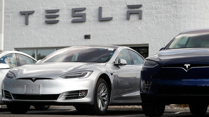 In this July 8, 2018, photo, 2018 Model 3 sedan sits next to a Model X on display outside a Tesla showroom in Littleton, Colo. Board members at Tesla are evaluating CEO and Chairman Elon Musk’s $72 billion proposal to take the electric car and solar panel maker private. Six of nine members say in a statement Wednesday, Aug. 8, that Musk began talking with the board about the move last week.