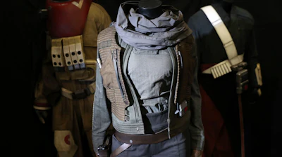 Costumes from Rogue One: A Star Wars Story including Felicity Jones's characters' costume, center, (estimate $19,500-$32,500) on display in the Prop Store head office.