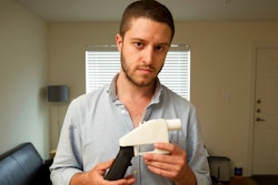 In this May 10, 2013, file photo, Cody Wilson, the founder of Defense Distributed, shows a plastic handgun made on a 3D-printer at his home in Austin, Texas. Eight states filed suit Monday, July 30, 2018, against the Trump administration over its decision to allow a Texas company to publish downloadable blueprints for a 3D-printed gun, contending the hard-to-trace plastic weapons are a boon to terrorists and criminals and threaten public safety.