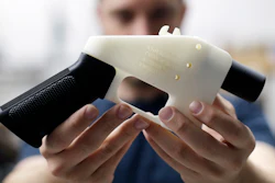 In this Aug. 1, 2018, file photo, Cody Wilson, with Defense Distributed, holds a 3D-printed gun called the Liberator at his shop in Austin, Texas. A federal judge in Seattle has granted an injunction that prohibits the Trump administration from allowing a Texas company to post 3D gun-making plans online.