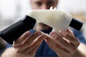 In this Aug. 1, 2018, file photo, Cody Wilson, with Defense Distributed, holds a 3D-printed gun called the Liberator at his shop in Austin, Texas. Eleven states have joined eight others and the District of Columbia in a federal lawsuit that seeks to block a settlement the Trump administration reached with a company that wants to post online plans to make 3D firearms on a printer.