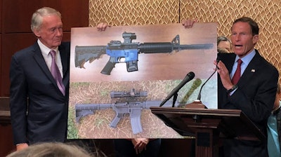 Sen. Edward Markey, D-Mass., left, and Sen. Richard Blumenthal, D-Ct., display a photo of a plastic gun on Tuesday, July 31, 2018, on Capitol Hill in Washington. Democrats are calling on President Donald Trump to reverse an administration decision to allow a Texas company to make blueprints for a 3D-printed gun available online.