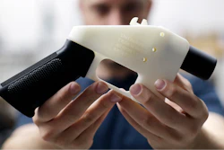 In this Aug. 1, 2018, file photo, Cody Wilson, with Defense Distributed, holds a 3D-printed gun called the Liberator at his shop in Austin, Texas. A federal judge in Seattle has granted an injunction that prohibits the Trump administration from allowing a Texas company to post 3D gun-making plans online.