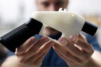 In this Aug. 1, 2018, file photo, Cody Wilson, with Defense Distributed, holds a 3D-printed gun called the Liberator at his shop in Austin, Texas. A federal judge in Seattle has granted an injunction that prohibits the Trump administration from allowing a Texas company to post 3D gun-making plans online.