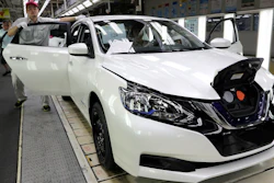A worker inspects a Nissan Sylphy Zero Emission, Nissan's first all-electric vehicle built in China, at a production line in Guangzhou, Guangdong province, China, Monday, Aug. 27, 2018. The Sylphy is part of a wave of dozens of electric models planned by global automakers for China where the government is pressing them to accelerate development of the technology.