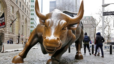 This Wednesday, Feb. 7, 2018 file photo show the Charging Bull sculpture by Arturo Di Modica, in New York's Financial District. The U.S. stock market is poised this week to pass a surprising milestone, rising for the longest, unbroken stretch of time in the history of U.S. stock trading. If stocks don’t drop significantly in the next three days, the bull market that began in March 2009 will have lasted nine years, five months and 13 days. It’s a record that few would have predicted when the stocks finally found their footing after a 50 percent plunge during the financial crisis.