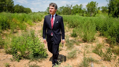 In this July 25, 2018, photo, Stephen Bell, president and CEO of the Arkadelphia Area Chamber of Commerce, shows parts of the 900-acre site of what he hopes will be a new paper mill, one of several Chinese-backed deals Arkansas has landed in recent years, in Arkadelphia, Ark. State and local officials in Arkansas are scrambling to preserve development deals with Chinese companies amid President Donald Trump's escalating tariff battle.