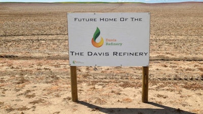 This July 19, 2018, file photo, shows a sign on property, near southwest Belfield, N.D, for the future home of the Davis Refinery near Theodore Roosevelt National Park. Opponents of an oil refinery planned near Theodore Roosevelt National Park in North Dakota are imploring state regulators to give them a chance to explore whether the developer is being truthful about the project's size. Meridian Energy Group maintains it doesn't need a state siting permit because the $800 million Davis Refinery won't have a big enough capacity.
