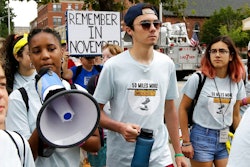 David Hogg, center, a survivor of the school shooting at Marjory Stoneman Douglas High School, in Parkland, Fla., walks in a planned 50-mile march, Thursday, Aug. 23, 2018, in Worcester, Mass. The march, held to call for gun law reforms, began Thursday, in Worcester, and is scheduled to end Sunday, Aug. 26, in Springfield, Mass., at the headquarters of gun manufacturer Smith & Wesson.