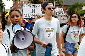 David Hogg, center, a survivor of the school shooting at Marjory Stoneman Douglas High School, in Parkland, Fla., walks in a planned 50-mile march, Thursday, Aug. 23, 2018, in Worcester, Mass. The march, held to call for gun law reforms, began Thursday, in Worcester, and is scheduled to end Sunday, Aug. 26, in Springfield, Mass., at the headquarters of gun manufacturer Smith & Wesson.