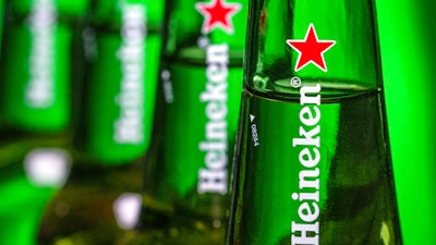 In this file photo dated Friday, March 30, 2018, bottles of Heineken beer are photographed in Washington, USA. Dutch brewing company Heineken said in a statement Friday Aug, 3, 2018, it is buying a 40 percent stake in the company that controls China’s biggest beer maker, China Resources Beer.