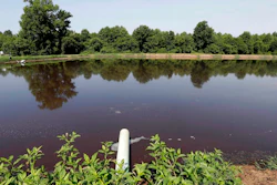In this July 21, 2017 file photo, a hog waste pond is seen at a farm that has hogs owned by Smithfield Foods in Farmville, N.C. A federal jury decided Friday, Aug. 3, 2018, that the world's largest pork producer should pay $473.5 million to neighbors of three North Carolina industrial-scale hog farms for unreasonable nuisances they suffered from odors, flies and rumbling trucks. The jury found that Smithfield Foods owes compensation to 16 neighbors who complained in their lawsuit that the company failed to stop “the obnoxious, recurrent odors and other causes of nuisance” resulting from closely packed hogs, which “generate many times more sewage than entire towns.”