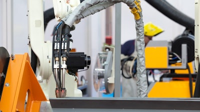 Industrial Welding Robot Arm, Blurred Welder In The Background 629761110 727x485 (1)