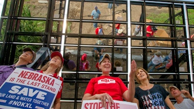 In this file photo, protesters in Nebraska stand in opposition to the 1,184-mile Keystone XL pipeline. The Rapid City Journal has reported that TransCanada Corp. has filed eminent domain petitions in South Dakota state court against parcels of Harding County land owned by two families.