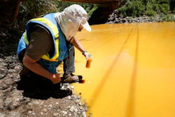 In this Aug. 6, 2015, file photo, Dan Bender of the La Plata County Sheriff's Office takes a water sample from the Animas River near Durango, Colo., after the U.S. Environmental Protection Agency accidentally triggered a spill of 3 million gallons of wastewater from the mine. The Obama administration said it could not legally repay any of the claims for damage from the spill, but the Trump administration promised last year to reconsider. As of Friday, Aug. 3, 2018, no claims had been paid, but the agency said it is continuing to review them.