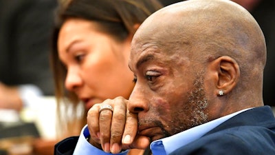 In this July 9, 2018, file photo, Plaintiff Dewayne Johnson, right, reacts while attorney Brent Wisner, not seen, speaks about his condition during the Monsanto trial in San Francisco. Monsanto is being accused of hiding the dangers of its popular Roundup products. A San Francisco jury on Friday, Aug. 10, 2018, ordered agribusiness giant Monsanto to pay $289 million to a former school groundskeeper dying of cancer, saying the company's popular Roundup weed killer contributed to his disease. The lawsuit brought by Johnson was the first to go to trial among hundreds filed in state and federal courts saying Roundup causes non-Hodgkin's lymphoma, which Monsanto denies.