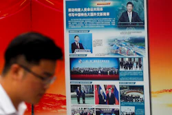 A man walks by a government propaganda billboard promoting Chinese President Xi Jinping's signature 'One Belt One Road' outside a subway station in Beijing, Tuesday, Aug. 28, 2018. Chinese officials on Monday defended Beijing's initiative to build a 'New Silk Road' of railways and other infrastructure across Asia against complaints it leaves host countries with too much debt after Malaysia canceled two high-profile projects. The officials said President Xi Jinping's signature foreign policy initiative is creating assets that are needed by developing countries but might take time to pay off.