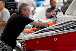 In this July 11, 2018 file photo, workers put finishing touches on boat exteriors at Regal Marine Industries in Orlando, Fla. American boat makers are getting pummeled on multiple fronts by tariffs and stand to be among the industries hardest-hit by the escalating trade war.