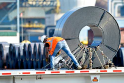 In this July 25, 2018, photo a truck driver chains down a roll of steel to his flatbed at the NUCOR Steel Gallatin plant in Ghent, Ky. The rolls, weighing as much as 20 tons, are transported one at a time. On Wednesday, Aug. 15, the Federal Reserve reports on U.S. industrial production for July.